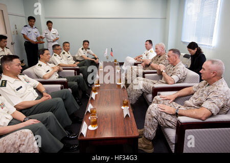 U.S. Marines Maj. Gen. Charles L. Hudson, bottom right, the commanding general of Marine Corps Installations Pacific, right, Commandant of the Marine Corps Gen. Joseph F. Dunford Jr., center right, and Lt. Gen. John A. Toolan, third right, the commanding general for Marine Forces Pacific, listen to Japan Gen. Kiyofumi Iwata, center left, the chief of staff of the Japan Ground Self-Defense Force, before the Reunion of Honor ceremony at Iwo To, Japan, March 21, 2015. Iwo Jima veterans, families, Marines, Japanese troops and officials attended the ceremony commemorating the lives of those lost in Stock Photo