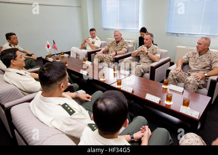 U.S. Marines Maj. Gen. Charles L. Hudson, right, the commanding general of Marine Corps Installations Pacific, Commandant of the Marine Corps Gen. Joseph F. Dunford Jr., top center, and Lt. Gen. John A. Toolan, top second left, the commanding general for Marine Forces Pacific, listen to Japan Gen. Kiyofumi Iwata, left, the chief of staff of the Japan Ground Self-Defense Force, before the Reunion of Honor ceremony at Iwo To, Japan, March 21, 2015. Iwo Jima veterans, families, Marines, Japanese troops and officials attended the ceremony commemorating the lives of those lost in one of the most ic Stock Photo