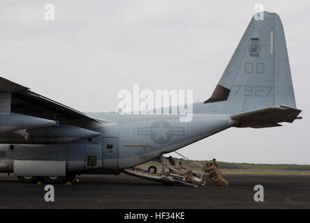 Marines with Marine Aerial Refueler Transport Squadron 152 load a staircase onto a Lockheed KC-130J Hercules after the Reunion of Honor Ceremony on Iwo To, formally known as Iwo Jima, March 21, 2015. The Reunion of Honor is a ceremony honoring veterans still alive from the battle of Iwo Jima in 1945. VMGR-152 provided transportation for Marines, VIPs and vehicles in support of the reunion this year. (U.S. Marine Corps photo by Lance Cpl. Carlos Cruz Jr.) VMGR-152 supports Reunion of Honor in Iwo To 150321-M-KE800-040 Stock Photo