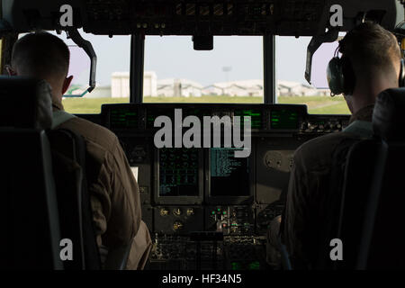 Capt. Charles Casey, left, an aircraft commander with Marine Aerial Refueler Transport Squadron 152, and 1st Lt. Jacob Billups, a pilot with VMGR-152, prepare to take flight to Iwo To, formally known as Iwo Jima, from Kadena Air Base, Japan, March 22, 2015. VMGR-152 provided transportation for Marines, VIPs and vehicles. The Reunion of Honor is a ceremony honoring veterans still alive from the battle of Iwo Jima in 1945. (U.S. Marine Corps photo by Lance Cpl. Carlos Cruz Jr.) VMGR-152 supports Reunion of Honor in Iwo To 150322-M-KE800-048 Stock Photo