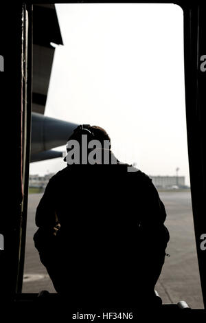 Cpl. Eli Wallace, a crew master with Marine Aerial Refueler Transport Squadron 152, awaits for take-off on a Lockheed KC-130J Hercules on Kadena Air Base, Japan, March 22, 2015. VMGR-152 flew back and forth from Kadena to Iwo To, formally known as Iwo Jima, providing transportation for Marines, VIPs and vehicles. The Reunion of Honor is a ceremony honoring veterans still alive from the battle of Iwo Jima in 1945. (U.S. Marine Corps photo by Lance Cpl. Carlos Cruz Jr.) VMGR-152 supports Reunion of Honor in Iwo To 150322-M-KE800-078 Stock Photo