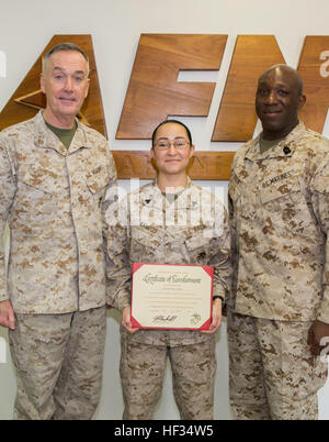 Gen. Joseph Dunford, Commandant of the Marine Corps, and Sgt. Maj. Ronald Green, Sergeant Major of the Marine Corps, pose with Cpl. Guadalupe Campos, a broadcaster with American Forces Network, after her reenlistment during a visit to Marine Corps Air Station Iwakuni, Japan, March 24, 2015. Campos was named Marine Corps Installations Command Marine of the Year for 2014. During their visit, Dunford and Green also conducted an all-hands brief and toured some of the units aboard station including Marine All-Weather Fighter Attack Squadron 242 and Marine Aviation Logistics Squadron 12. Dunford als Stock Photo