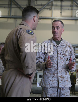 Gen. Joseph Dunford. Commandant of the Marine Corps, talks to Lt. Col. Shawn Basco, commanding officer of Marine All-Weather Fighter Attack Squadron 242, during his visit to Marine Corps Air Station Iwakuni, Japan, March 24, 2015. Dunford and Sgt. Maj. Ronald Green, Sergeant Major of the Marine Corps, spent their visit speaking to service members on the future of the Marine Corps and answered any questions they had. Commandant of the Marine Corps visits MCAS Iwakuni 150324-M-QA203-013 Stock Photo