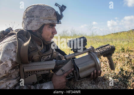 A U.S. Marine with Battalion Landing Team 3rd Battalion, 1st Marine Regiment, 15th Marine Expeditionary Unit, provides security during a mechanized raid aboard Camp Pendleton, Calif., as part of Composite Training Unit Exercise (COMPTUEX) March 24, 2015. During the training, the 15th MEU’s ground combat element conducted a ship-to-shore assault with AAV-7A1 Assault Amphibious Vehicles launching from the USS Rushmore (LSD 47). (U.S. Marine Corps photo by Sgt. Emmanuel Ramos/Released) Hard Hit, Marines train for raid missions 150324-M-ST621-094 Stock Photo