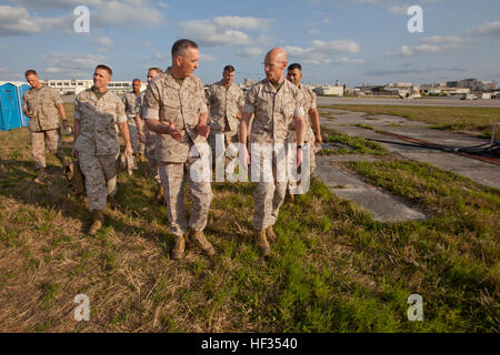 Commandant of the Marine Corps, Gen. Joseph F. Dunford, Jr., center, walks with Lt. Col. John C. Barry, front right, the commanding officer of Marine Air Control Squadron 4, at Camp Futenma, Japan, March 26, 2015. Dunford and Sgt. Maj. of the Marine Corps Ronald L. Green met with and thanked Marines during their first Western Pacific trip. (U.S. Marine Corps photo by Sgt. Gabriela Garcia/Released) CMC and SMMC Visit III MEF Day Two 150326-M-SA716-342 Stock Photo