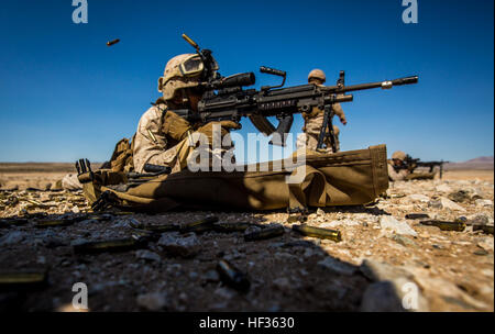 U.S. Marines with security platoon, Headquarters Battalion, 1st Marine Division, participate in a live-fire training exercise during Desert Scimitar 2015 at Marine Corps Air Ground Combat Center Twentynine Palms, Calif., April 7, 2015. DS15 is a combined arms exercise focused on the training and preparation of 1st Marine Division for deployment as the Ground Combat Element of a Marine Air-Ground Task Force. (U.S. Marine Corps Photo by Pfc. Nathaniel Castillo/Released) Marines train with K-9 partners 150407-M-QP075-227 Stock Photo