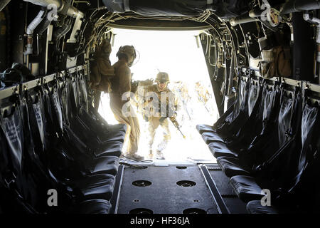 U.S. Marines assigned to Charley Company, 1st Battalion, 7th Marine Regiment (1/7), 1st Marine Division, board an MV-22 Osprey tiltrotor aircraft with Marine Medium Tiltrotor Squadron (VMM) 166, Marine Aircraft Group 16, 3rd Marine Aircraft Wing, during Desert Scimitar 2015 (DS15) on Fort Hunter Liggett, Calif., April 11, 2015. VMM-166 and 1/7 conducted a long-range raid as part of DS15, a combined arms exercise that allows units to maintain readiness and meet current and future real-world demands. (U.S. Marine Corps photo by Cpl. Darien J. Bjorndal, 3rd Marine Aircraft Wing/ Released) US Mari Stock Photo