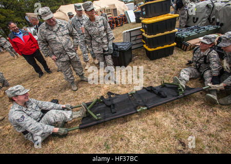 Brig. Gen. Michael L. Cunniff, third from left, the Adjutant General of new Jersey, watches as Airmen with 107th Air Wing Medical, New York Air National Guard, group assemble stretchers during a full scale Homeland Response Force exercise involving units from the New Jersey and New York Army and Air National Guard at Joint Base McGuire-Dix-Lakehurst, N.J., April 17, 2015. From April 14-19, 2015, nearly 600 New Jersey and New York Army and Air National Guardsmen participated in the joint-training event with New Jersey Office of Emergency Management and New Jersey State Police Task Force 1. The  Stock Photo