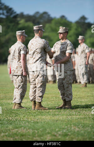 U.S. Marine Corps Lance Cpl. Arron K. Sekulov, right, an entry-level Marine with Delta Company (Delta Co.) Infantry Training Battalion, School of Infantry-East receives an award from Capt. Karl T. Kurbikoff, Company Commander, Delta Co., during the Delta Co. Graduation Ceremony on Camp Geiger, N.C., April 23, 2015. The Marines of Delta Co. completed the nine week course as part of their last stage of initial military training and will be sent to units in the operating forces. (U.S. Marine Corps photo by Lance Cpl. Andrew Kuppers, SOI-East Combat Camera/Released) Delta Co. Graduation from ITB 1 Stock Photo