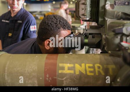 British Royal Navy Able Seaman Ratu Rodelana, logistics steward with the HMS Lancaster, looks through the scope of an M40A5 sniper rifle during a tour aboard the amphibious assault ship USS Wasp (LHD 1) while out at sea April 30, 2015. U.S. Marines and U.S. Navy Sailors with the 22nd Marine Expeditionary Unit from Marine Corps Base Camp Lejeune, N.C., participated in Navy Week 2015 in New Orleans April 23-29 and Fleet Week Port Everglades, Fla., May 4-10. The purpose of Navy Week was to showcase the strength and capabilities of the Navy-Marine Corps team through tours, static displays and comm Stock Photo