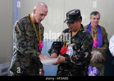 Armed Forces of the Philippines Maj. Gen. Emeraldo C. Magnaye, right, and U.S. Marine Maj. Gen. Richard Simcock prepare to throw rice and coins during a dedication ceremony May 14 in Guinobatan, Albay province, Philippines. The rice and coins represent good luck and fortune in the future. Dedication ceremonies were held around Albay to recognize the completion of the five engineering civic assistance program sites taking place as a part of Exercise Balikatan, including renovations of a school, building of classrooms, and construction of a health center. The exercise is currently in its 30th it Stock Photo