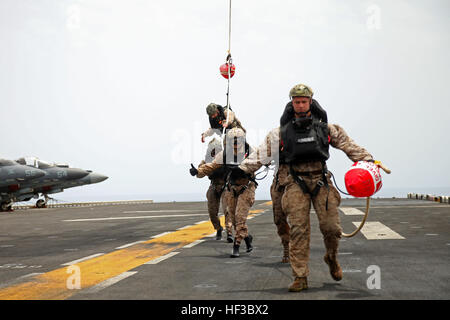 150528-M-QZ288-055: GULF OF ADEN (May 28, 2015) Reconnaissance Marines with the 24th Marine Expeditionary Unit’s Maritime Raid Force, sourced from Force Reconnaissance Company, 2nd Reconnaissance Battalion, are recovered via a special patrol insertion/extraction line onto the amphibious assault ship USS Iwo Jima (LHD 7) after conducting helo-cast training in the Gulf of Aden, May 28, 2015. The 24th MEU is embarked on the Iwo Jima Amphibious Ready Group and deployed to maintain regional security in the U.S. 5th Fleet area of operations. (U.S. Marine Corps photo by Lance Cpl. Austin A. Lewis/Rel Stock Photo