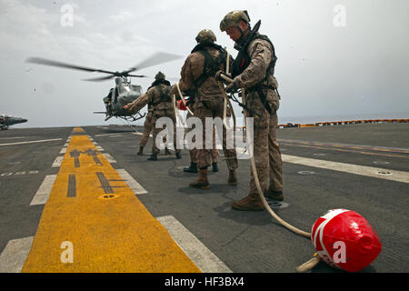150528-M-QZ288-087: GULF OF ADEN (May 28, 2015) Reconnaissance Marines with the 24th Marine Expeditionary Unit’s Maritime Raid Force, sourced from Force Reconnaissance Company, 2nd Reconnaissance Battalion, conduct special patrol insertion/extraction training from a UH-1Y Huey aboard the amphibious assault ship USS Iwo Jima (LHD 7) in the Gulf of Aden, May 28, 2015. The Huey belongs to Marine Medium Tiltrotor Squadron 365 (Reinforced), 24th MEU. The 24th MEU is embarked on the Iwo Jima Amphibious Ready Group and deployed to maintain regional security in the U.S. 5th Fleet area of operations. ( Stock Photo