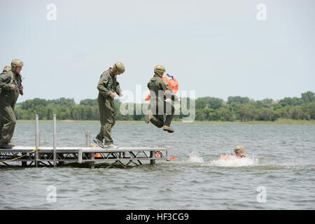 Aircrew from the Nebraska Air National Guard's 155th Air Refueling Wing and 170th Operations Support Squadron plunge into Branched Oak Lake, Neb., swim to 20-man life rafts and await rescue by a UH-60 Black Hawk helicopter during a survival exercise June 6. The aircrew members enhance survival skills on land and water with hands-on training. Water Survival Training 150606-Z-GK473-660 Stock Photo