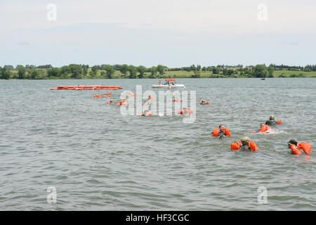 Aircrew from the Nebraska Air National Guard's 155th Air Refueling Wing and 170th Operations Support Squadron plunge into Branched Oak Lake, Neb., swim to 20-man life rafts and await rescue by a UH-60 Black Hawk helicopter during a survival exercise June 6. The aircrew members enhance survival skills on land and water with hands-on training. Water Survival Training 150606-Z-GK473-676 Stock Photo