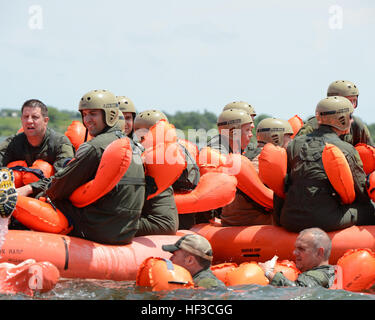 Aircrew from the Nebraska Air National Guard's 155th Air Refueling Wing and 170th Operations Support Squadron plunge into Branched Oak Lake, Neb., swim to 20-man life rafts and await rescue by a UH-60 Black Hawk helicopter during a survival exercise June 6. The aircrew members enhance survival skills on land and water with hands-on training. Water survival training 150606-Z-GK473-718 Stock Photo