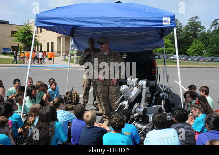 U.S. Air Force Tech. Sgt. John Hurley, right, and Tech Sgt. Philip Douglass, explosive ordnance disposal airmen from the New Jersey Air National Guard's 177th Fighter Wing, speak to fifth-grade students at Dr. Joyanne D. Miller School, Egg Harbor Township, N.J., during the 19th annual DARE day graduation. Members of the Wing came together with Egg Harbor Township Police, emergency medical services, Atlantic County SWAT, West Atlantic City Volunteer Fire Company, and Cardiff Volunteer Fire Company to celebrate the fifth-grade students' completion of the DARE program. (U.S. Air National Guard ph Stock Photo