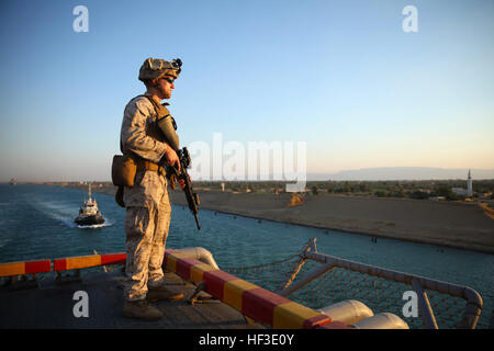 Cpl. Chris R. Dalessandro, a low-altitude air defense gunner with Marine Medium Tiltrotor Squadron 365 (Reinforced), 24th Marine Expeditionary Unit, provides security while the amphibious assault ship USS Iwo Jima (LHD 7) sails through the Suez Canal, June 21, 2015. The 24th MEU and Iwo Jima Amphibious Ready Group transited through the canal, a 120-mile long waterway connecting the Red Sea to the Mediterranean, and entered the U.S. 6th Fleet area of operations. The 24th MEU is deployed on the ships of the Iwo Jima ARG in support of U.S. national security interests in the U.S. 6th Fleet area of Stock Photo