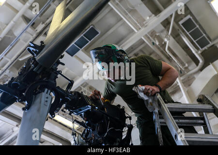 ARABIAN SEA (June 24, 2015)  U.S. Marine Cpl. Dylan Kelley applies an anti-corrosion solution to helicopter rotor components aboard the USS Anchorage (LPD 23). This type of maintenance keeps the aircraft running in top condition during the deployment. Anchorage is part of the Essex Amphibious Ready Group, and, with the embarked 15th Marine Expeditionary Unit, is deployed in support of maritime security operations and theater security cooperation efforts in the U.S. 5th Fleet area of operations. (U.S. Marine Corps photo by Sgt. Jamean Berry/Released) Detail work, U.S. Marines maintain aircraft 