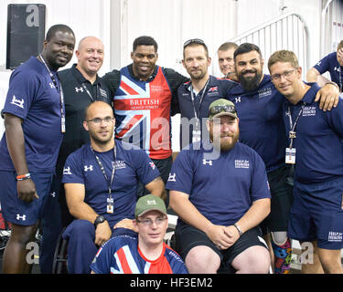 Retired professional football player and 1982 Heisman Trophy winner Herschel Walker takes his place amongst newfound friends from the United Kingdom, Team British Armed Forces. Walker visited with competitors during the 2015 DoD Warrior Games on Marine Corps Base Quantico. Walker has journeyed to each Warrior Games since its inception and has no intention of stopping. “These are true athletes,” Walker said. “Watching their determination is an inspiration to me.” (U.S. Army photo by AW2 Staff Sgt. Tracy J. Smith) Team Army set sights on gold for Day 5 of the 2015 Warrior Games 150626-Z-PA893-00 Stock Photo