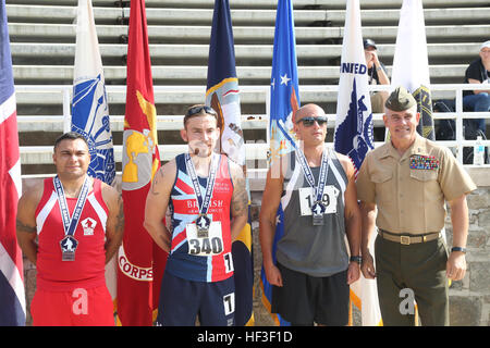 U.S. Marine Corps Staff Sgt. Jose Ramirez, left, receives a bronze medal during the 2015 Department of Defense (DoD) Warrior Games track competition at Marine Corps Base (MCB) Quantico, Va., June 28, 2015. Ramirez is a member of the 2015 DoD Warrior Games All-Marine Team. The 2015 DoD Warrior Games, held at MCB Quantico June 19-28, is an adaptive sports competition for wounded, ill, and injured Service members and veterans from the U.S. Army, Marine Corps, Navy, Air Force, Special Operations Command, and the British Armed Forces. (U.S. Marine Corps photo by Cpl. Mark Watola/Released) 2015 DoD  Stock Photo