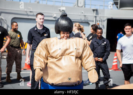 A Navy sailor participates in sumo suit wrestling during the Fourth of July 'steel beach' picnic on the flight deck of the USS Bonhomme Richard (LHD 6), at sea, July 4, 2015. The 31st Marine Expeditionary Unit is currently conducting their annual Fall Patrol of the Asia-Pacific region. (U.S. Marine Corps photo by GySgt Ismael Pena/Released) Fourth of July celebration aboard the USS Bonhomme Richard 150704-M-CX588-136 Stock Photo