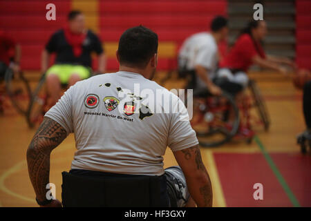 Donning a Wounded Warrior Battalion West-Detachment Hawaii T-shirt, Michael Hoomanawanui, a Super Bowl champion and starting tight end with the New England Patriots, prepares for a game of wheelchair basketball at the Semper Fit Center gym aboard Marine Corps Base Hawaii, July 16, 2015. The purpose of Hoomanawanui’s visit was to connect with and learn more about the Marines and Sailors aboard MCB Hawaii, as well as show his support for the service members’ sacrifices. (U.S. Marine Corps photo by Lance Cpl. Harley Thomas/Released) Wounded Warriors play ball with NFL champ 150716-M-SB674-002 Stock Photo