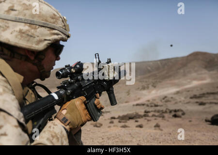 ARTA BEACH, Djibouti (July 22, 2015) U.S. Marine Lance Cpl. Brandon Kalz fires an M203 grenade launcher during a grenade accuracy exercise.  Kalz is a team leader with Battalion Landing Team 3rd Battalion, 1st Marine Regiment, 15th Marine Expeditionary Unit. Elements of the 15th Marine Expeditionary Unit are ashore in Djibouti for sustainment training to maintain and enhance the skills they developed during their pre-deployment training period.  The 15th MEU is currently deployed in support of maritime security operations and theater security cooperation efforts in the U.S. 5th and 6th Fleet a Stock Photo