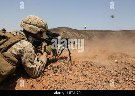 ARTA BEACH, Djibouti (July 22, 2015) A U.S. Marine with Battalion Landing Team 3rd Battalion, 1st Marine Regiment, 15th Marine Expeditionary Unit, fires an infantry automatic rifle during a squad-attack exercise.  The Marines of BLT 3/1 executed a series of attack and maneuver drills consisting of, machine gun, squad and night attacks.  Elements of the 15th Marine Expeditionary Unit are ashore in Djibouti for sustainment training to maintain and enhance the skills they developed during their pre-deployment training period.  The 15th MEU is currently deployed in support of maritime security ope Stock Photo