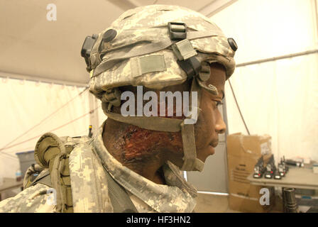 Spc. Antonio Thompson, of Ashland, Miss., assigned to Company D, 106th Support Battalion, 155th Armored Brigade Combat Team, wears moulage to simulate a burn during an Exportable Combat Training Capability exercise at Camp Shelby Joint Forces Training Center, near Hattiesburg, Miss., on July 29, 2015. The XCTC exposes Guard Soldiers to combat-training experiences needed to support Army commitments worldwide. Approximately 4,600 Soldiers from Mississippi Army National Guard, active, and Reserve components are participating in the event. (Mississippi National Guard photo by Sgt. DeUndra Brown, 1 Stock Photo