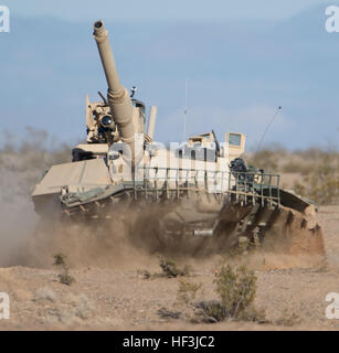 Soldiers from D Company, 3rd Battalion, 116th Cavalry Brigade Combat Team (CBCT), Oregon Army National Guard, maneuver an M1A2 Abrams tank, with attached plow, toward an obstacle breach operation during a company live fire exercise, Aug. 16, at the National Training Center, Fort Irwin, Calif. The 116th CBCT is participating in battle simulation scenarios composed of more than 5,200 Soldiers with National Guard units from 10 states, the U.S. Army Reserve and active duty U.S Army Soldiers. (Photo by Maj. W. Chris Clyne, 115th Mobile Public Affairs Detachment) National Guard conducts live fire at Stock Photo