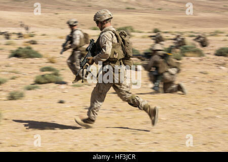 Southwest Asia (Aug. 18, 2015) U.S. Marine Lance Cpl. Robert Hole rushes with his fellow Marines while simulating a squad attack during sustainment training. Hole is a team leader with India Company, Battalion Landing Team 3rd Battalion, 1st Marine Regiment, 15th Marine Expeditionary Unit.  The 15th MEU, embarked aboard the ships of the Essex Amphibious Ready Group, is a forward-deployed, flexible sea-based Marine air-ground task force capable of engaging with regional partners and contributing to regional security. (U.S. Marine Corps photo by Sgt. Jamean Berry/Released) 15th MEU Marines train Stock Photo