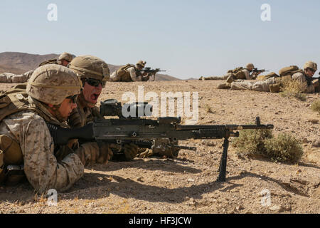 Southwest Asia (Aug. 18, 2015) U.S. Marine Lance Cpl. Taylor Bauer and Lance Cpl. Alex Ledford with India Company, Battalion Landing Team 3rd Battalion, 1st Marine Regiment, 15th Marine Expeditionary Unit, practices emplacing an M240B machine gun during sustainment training. The 15th MEU, embarked aboard the ships of the Essex Amphibious Ready Group, is a forward-deployed, flexible sea-based Marine air-ground task force capable of engaging with regional partners and contributing to regional security. (U.S. Marine Corps photo by Sgt. Jamean Berry/Released) 15th MEU Marines train in Southwest As Stock Photo