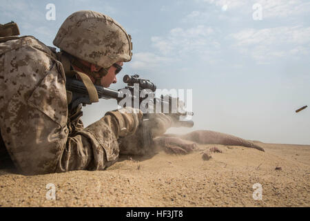 KUWAIT (Aug. 25, 2015) U.S. Marine Cpl. Willie Stevens engages targets during mechanized squad attack training. Stevens is a team leader with Kilo Company, Battalion Landing Team 3rd Battalion, 1st Marine Regiment, 15th Marine Expeditionary Unit. The training focused on the squad’s ability to work as a cohesive unit while using AAV-7 Amphibious Assault Vehicles and M1A1 Abrams tanks to effectively eliminate enemy targets. Elements of the 15th MEU are ashore in Kuwait for sustainment training to maintain and enhance the skills they developed during their pre-deployment training period. The 15th Stock Photo