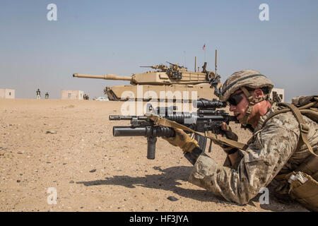 KUWAIT (Aug. 28, 2015) U.S. Marine Cpl. Jeffery Salois aims at a target while conducting mechanized squad attacks in an urban environment. Salois is a team leader with Kilo Company, Battalion Landing Team 3rd Battalion, 1st Marine Regiment, 15th Marine Expeditionary Unit. During the training, Marines learned how to incorporate an M1A1 Abrams tank in squad attacks in an urban environment. Elements of the 15th MEU are ashore in Kuwait for sustainment training to maintain and enhance the skills they developed during their pre-deployment training period.  The 15th MEU is embarked with the Essex Am Stock Photo