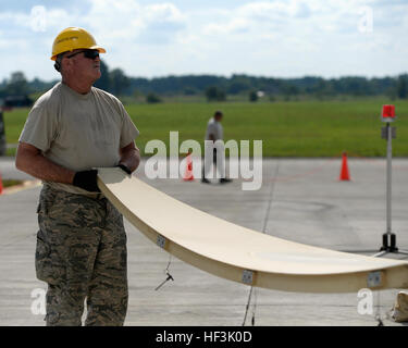 Senior Master Sgt. Charlie Sweetin, a communications infrastructure systems specialist with the 147th Maintenance Group, 147th Reconnaissance Wing, Texas Air National Guard, based at Ellington Field Joint Reserve Base in Houston, assembles a satellite Aug. 31, 2015, at Lielvarde Air Base, Latvia. The maintainers mobilized with other members of the wing to the Baltic nation where they deployed an entire MQ-1B Predator package, launching and recovering the first large-scale remotely piloted aircraft in Latvia. (Air National Guard photo by 1st Lt. Alicia Lacy/Released) US Air National Guard makes Stock Photo