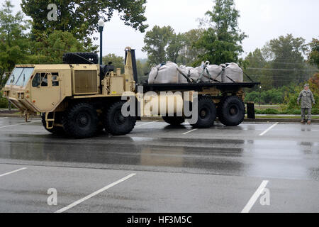 U.S. Soldiers from Alpha Company, 218th Brigade Support Battalion, South Carolina Army National Guard, deliver sandbags to the Columbia Riverfront Canal in an effort to repair the canal's breached levee, Oct. 5, 2015, during a statewide flood response. The South Carolina National Guard has been activated to support state and county emergency management agencies and local first responders as historic flooding impacts counties statewide. Currently, more than 1,100 South Carolina National Guard members have been activated in response to the floods. (U.S. Air National Guard video by Tech. Sgt. Cay Stock Photo