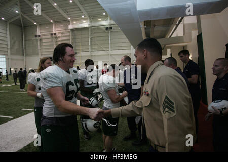 FLORHAM PARK, N.J. -- A Marine from 2nd Battalion, 25th Marine Regiment, meets with Alan Franca, left guard, New York Jets, during a tour of the team's practice facility Nov. 13. The team invited service members to their practice and Sunday the Jets will honor military veterans during their military appreciation day. (Official Marine Corps photo by Sgt. Randall A. Clinton) Alan Faneca Marine Corps Stock Photo