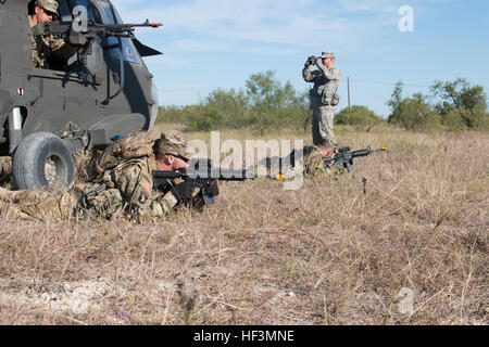 Soldiers from the California Army National Guard 1st Battalion, 140th Aviation Regiment, 40th Combat Aviation Brigade hit the ground running during a small unit tactics exercise at Fort Hood, Texas, Oct. 19, 2015. During this training scenario, Soldiers practiced surviving after a simulated UH-60 Black Hawk helicopter emergency landing. The 40th CAB was training to deploy to the Kuwait to support stability operations in 2016. (U.S. Army National Guard Photo/Spc. Rose Wolford/Released) 1-140th Aviation Battalion Soldiers train to survive 151019-Z-JM073-068 Stock Photo