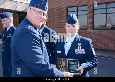 U.S. Air Force Master Sgt. Rebecca Tongen, installation emergency superintendent for the 145th Civil Engineering Squadron, receives the Outstanding Senior Non-Commissioned Officer of the Quarter award for July-September 2015, from Col. Marshall C. Collins, commander, 145th Airlift Wing, during a ramp formation held at the North Carolina Air National Guard Base, Charlotte Douglas International Airport, Dec. 6, 2015. Tongen has 14 years of military service. (U.S. Air National Guard photo by Senior Airman Laura Montgomery, 145th Public Affairs/Released) Ramp formation December 2015 151206-Z-RS771 Stock Photo