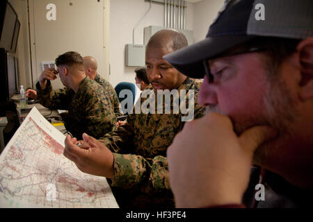 U.S. Marine Corps Gunnery Sgt. Dale Malone, with Marine Corps Air Support Squadron 3, references a map while conducting training in the combat convoy simulator on Camp Pendleton, Calif., Jan. 21, 2016. Education for these events was conducted by Training Support Division, which provides guidance to prepare Marines in realistic environments for operational utilization. (U.S. Marine Corps Photo by Lance Cpl. Roderick Jacquote, MCIWEST-MCB CamPen/Released) Training Support Division 160121-M-DU576-016 Stock Photo