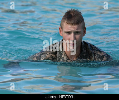 Arizona Army National Guard Spc. Michael Kringle, a forward observer assigned to the Recruiting and Retention Battalion, completes his second lap of a 100-meter swim event March 5 at Florence High School in Florence, Ariz. The swim was one of several events that took place during testing for the German Armed Forces Proficiency Badge. (U.S. Army National Guard photo by Staff Sgt. Brian A. Barbour) Arizona National Guard Soldiers partner with ROTC to compete for German Badge 160305-Z-LW032-003 Stock Photo