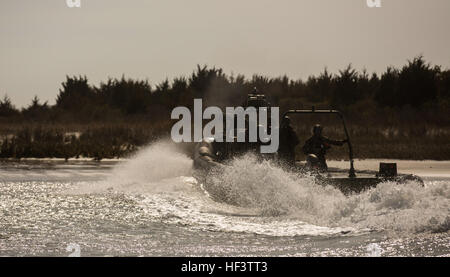 Dutch Marines with Fast Raiding Intercepting Special Forces Craft troop, 32nd Raiding Company, conduct a hot extraction exercise aboard Camp Lejeune, N.C., March 10, 2015. While one boat provides covering fire, the second FRISC gets as close as possible to the beach to extract any friendlies. This exercise is unique because the Dutch Marines aren’t afforded the opportunity to conduct this exercise on their home base, so they come to Camp Lejeune every year to conduct Hot Extraction drills. (U.S. Marines photo by Cpl. Justin T. Updegraff/Released) Dutch Marines strengthen battle tactics 160311- Stock Photo