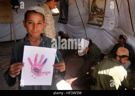 A 10-year-old Afghan boy proudly displays his turkey drawing during the first day of school at the Afghan national army compound just outside Forward Operating Base Geronimo Jan. 18. Marines and Sailors of 1st Battalion, 3rd Marine Regiment, will hold classes twice each week focused on reading, writing and counting in Pashto, art and geography. Marines, sailors host school for Afghans in Nawa DVIDS247250 Stock Photo