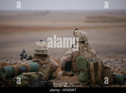 Marines from India Company, 3rd Battalion, 6th Marine Regiment, observe the countryside of Helmand province, Afghanistan, Feb. 5. India Company arrived at their current location in Helmand province by a combination of land and air transportation after securing a landing zone in the Afghan desert. Marines, Afghan Soldiers Insert Deep Into Key Afghan Terrain DVIDS250645 Stock Photo