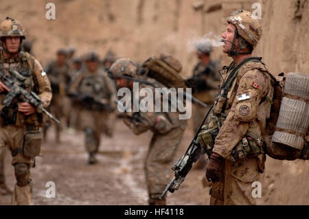 Canadian Forces Master Cpl. Dan King, company quarter master, takes a moment to himself to have a cigerate during a dismounted patrol, Feb. 5, 2010, Southern Afghanistan. Canadian Forces 3rd KANDAK 1/205 Corps and the U.S. Army Charlie Company 2508 Task Force Furry worked together mentoring the 3-1/205 Afghan National Army for a successful execution of Operation Mesmar. The mission objective was to clear several villages and fruit orchards in the southern most half of Terot Kulacha in search of IED's, weapons caches and illegal drugs. (U.S. Air Force photo by Senior Airman Kenny Holston) (Rele Stock Photo