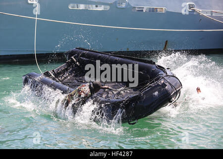 A Guyana service member climbs on top of a Rigid Inflatable Boat while conducting amphibious training during Exercise Tradewinds 2016 at Her Majesty Jamaica Ship CAGWAY, Port Royal, Jamaica, June 23, 2016. Tradewinds is a combined and joint exercise helping build the capacity of military forces from the U.S., Canada, Mexico, United Kingdom and France, and Caribbean nations to better respond to natural disasters, as well as land and maritime threats. (U.S. Marine Corps photo by Cpl. Samuel Guerra/Released) Tradewinds soldiers, Marines conduct amphibious ops training in Jamaica 160623-M-GL218-19 Stock Photo