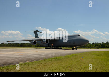 A U.S. Air Force Lockheed C-5 Galaxy transport aircraft taxis onto the runway at McEntire Joint National Guard Base, S.C., July 8, 2016. Approximately 300 U.S. Airmen and 12 F-16 Fighting Falcon jets from the 169th Fighter Wing at McEntire JNGB, S.C., are deploying to Osan Air Base, Republic of Korea, as the 157th Expeditionary Fighter Squadron in support of the U.S. Pacific Command Theater Security Package. (U.S. Air National Guard photo by Airman 1st Class Megan Floyd) SCANG TSP 747 Cargo Load 160708-Z-VD276-047 Stock Photo