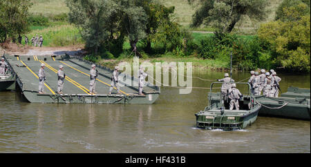 Soldiers with the 125th Multi Role Bridge Company, South Carolina National Guard, set up an improved ribbon brigde on the Olt River near Voila, Romania, August 1, during exercise Saber Guardian 16. Saber Guardian 16 is a multinational military exercise involving approximately 2,800 military personnel from ten nations including Armenia, Azerbaijan, Bulgaria, Canada, Georgia, Moldova, Poland, Romania, Ukraine and the U.S. The objectives of this exercise are to build multinational, regional and joint partnership capacity by enhancing military relationships, exchanging professional experiences, an Stock Photo