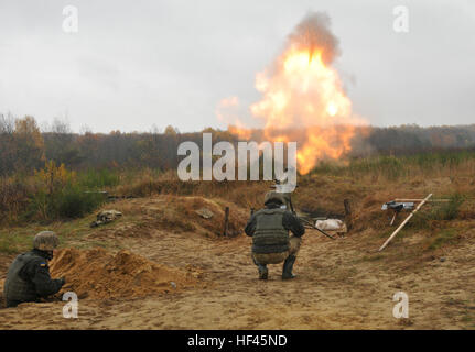 YAVORIV, Ukraine—A Ukrainian Soldier assigned to 1st Battalion, 80th Airmobile Brigade pulls a lanyard to fire a 120mm round from a mortar system, Nov. 9, before a direct lay training live-fire exercise at the International Peacekeeping and Security Center. The training exercise was observed/controlled by Soldiers assigned to 6th Squadron, 8th Cavalry Regiment, 2nd Infantry Brigade Combat Team, 3rd Infantry Division, along with Polish and Ukrainian instructors, as part of the Joint Multinational Training Group-Ukraine. JMTG-U’s mission is aimed at developing defensive skills and improving Ukra Stock Photo